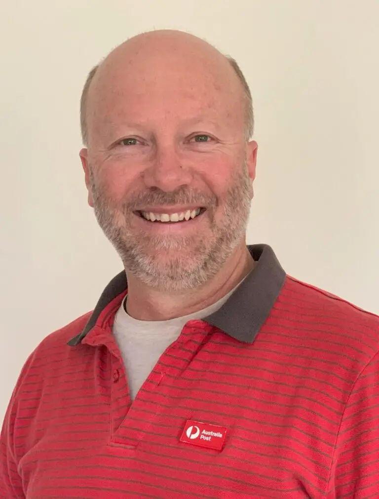 Smiling man wearing red Australia Post shirt