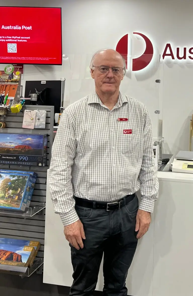 Australia Post employee standing at service counter